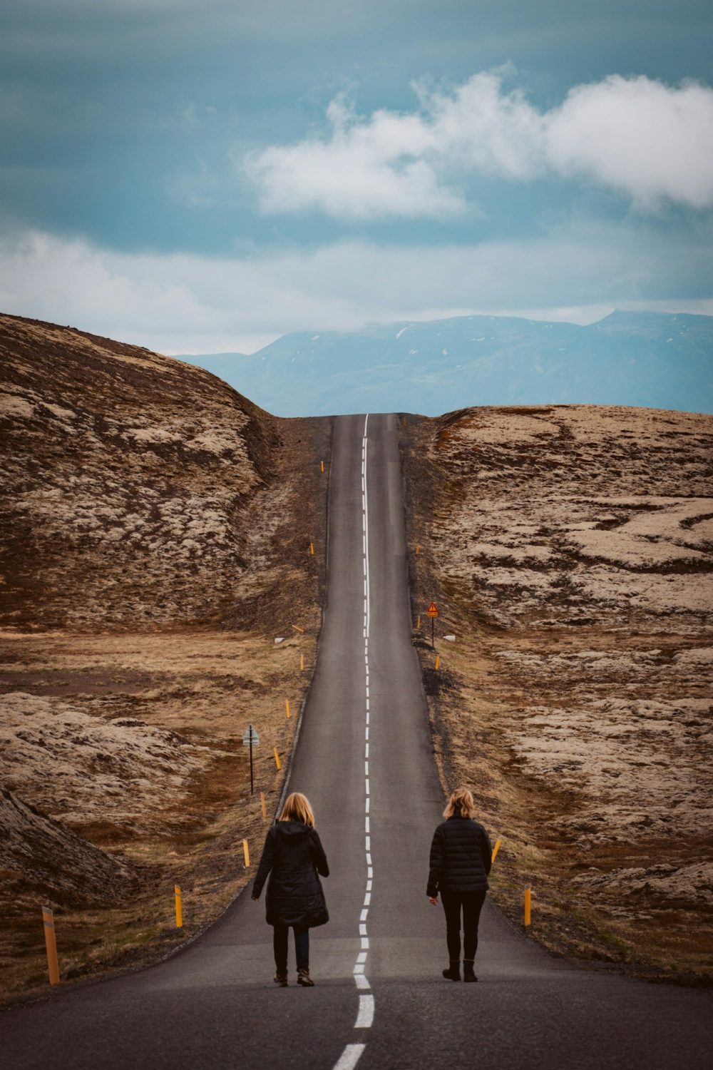 couple walking on road during daytime