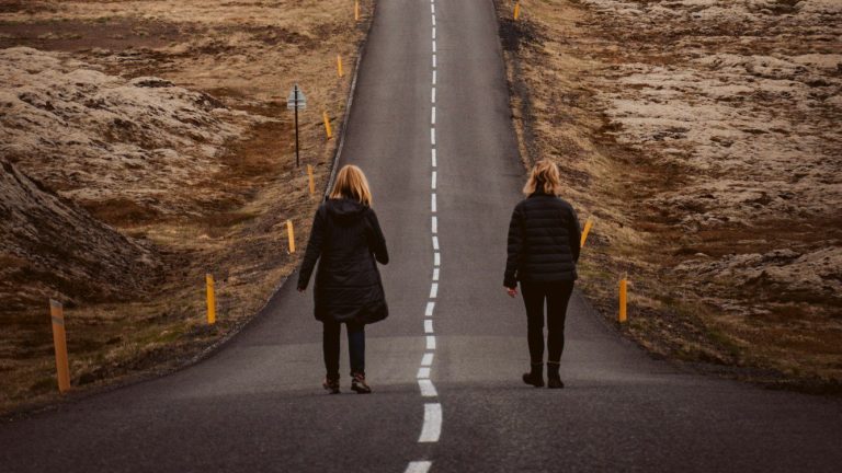 couple walking on road during daytime
